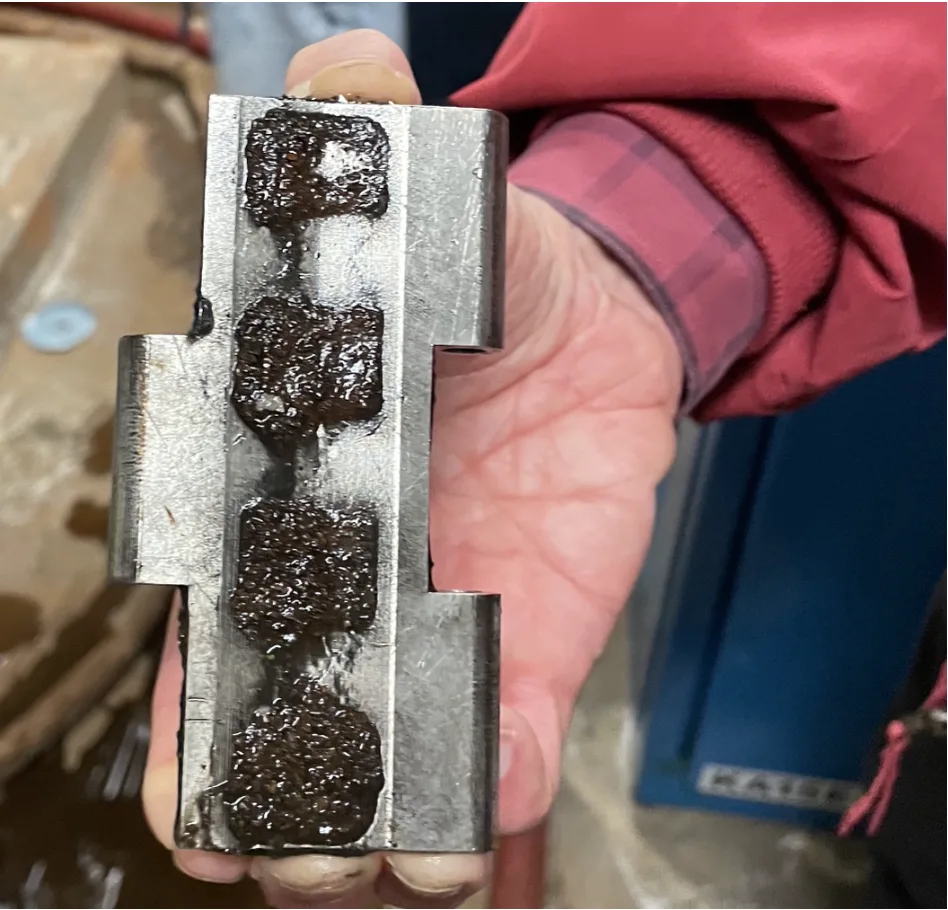 Close-up of HydroFlux magnetic link showing captured iron precipitate